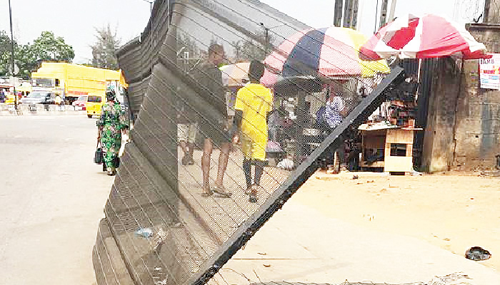 Lagos motorists demand removal of damaged metal net barricade